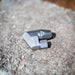 ENZ Bend Rotodrill sewer jetting nozzle with stainless‑steel tapered front, hex‑base connection, and engraved markings, shown on a rough concrete surface; 2¾‑inch rotating jet nozzle designed to negotiate bends and traps while clearing roots, debris, and blockages in 3–6 inch pipes at flows as low as 4 GPM, available in 1/4‑inch and 3/8‑inch connections.