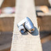 ENZ Bend Rotodrill sewer jetting nozzle with stainless‑steel tapered front and hex‑base connection, shown in close‑up on a workbench; 2¾‑inch rotating jet nozzle designed to negotiate bends and traps while clearing roots, debris, and blockages in 3–6 inch pipes at flows as low as 4 GPM, available in 1/4‑inch and 3/8‑inch connections.