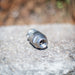 ENZ Bulldog rotating sewer jetting nozzle resting on a stone surface, featuring a stainless steel precision‑machined body with threaded inlet; built with an oil‑free braking system for controlled slow rotation and compatible with fresh or recycled water; engineered for cutting grease, roots, and heavy pipeline deposits using powerful 6-inch rear jets and a 1-inch forward jet, with optional 90‑degree descaling head available for removing tough scale from pipe walls.