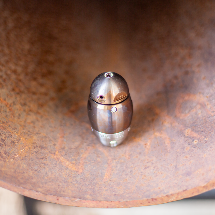 Warthog high‑pressure sewer jetter nozzle inside a corroded pipe, featuring a stainless steel body with precision rear and side jet ports engineered for powerful pulling, descaling, and flushing in 3–8 inch sewer and drain lines. Compact, durable, and fully rebuildable design optimized for professional pipeline cleaning and maintenance.