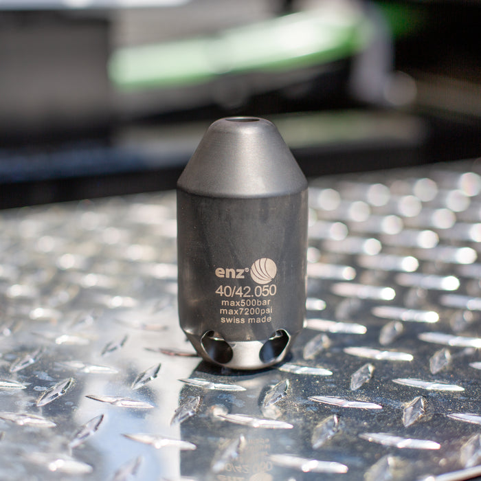 Enz Grenade 40/42.050 high‑pressure sewer jetting nozzle, Swiss‑made stainless steel rotary cleaning nozzle rated to 500 bar / 7200 psi, photographed on industrial diamond‑plate metal surface for professional drain and pipe cleaning.