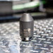 Enz Grenade 40/42.050 high‑pressure sewer jetting nozzle, Swiss‑made stainless steel rotary cleaning nozzle rated to 500 bar / 7200 psi, photographed on industrial diamond‑plate metal surface for professional drain and pipe cleaning.