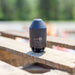 Enz Grenade 40/42.050 high‑pressure sewer jetting nozzle, Swiss‑made stainless steel rotary cleaning nozzle rated to 500 bar / 7200 psi, photographed outdoors on a wooden surface for industrial drain and pipe cleaning applications.