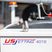 Reaper Rotating Nozzle displayed on a US Jetting 4018 jetter, featuring a stainless‑steel body with the REAPER logo and precision jet ports. This high‑pressure sewer jetting nozzle uses a powerful forward oscillating jet and four rear propulsion jets to cut through blockages, penetrate roots, and clear grease with a cone‑shaped spray pattern. Ideal for professional drain cleaning applications and available in multiple pressure and flow sizes from US Jetting.