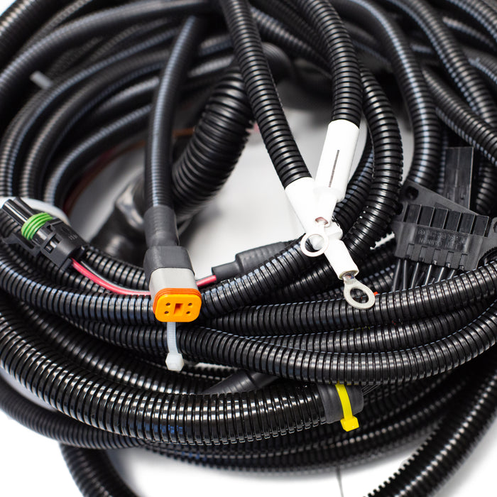 Tier 3 engine wiring harness with multi‑pin connectors, corrugated protective loom, and control‑panel leads for US Jetting jetter systems.