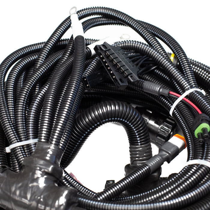 Tier 3 engine wiring harness with multi‑pin connectors, corrugated protective loom, and control‑panel leads for US Jetting jetter systems.