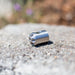 Stainless steel Digger Nozzle for sewer jetting, forward‑jet design with no rear jets to push debris and scale out of small pipes; manually pushed nozzle ideal for short runs under 100 feet during pipe‑lining prep, shown on a rough stone surface for detailed product display.