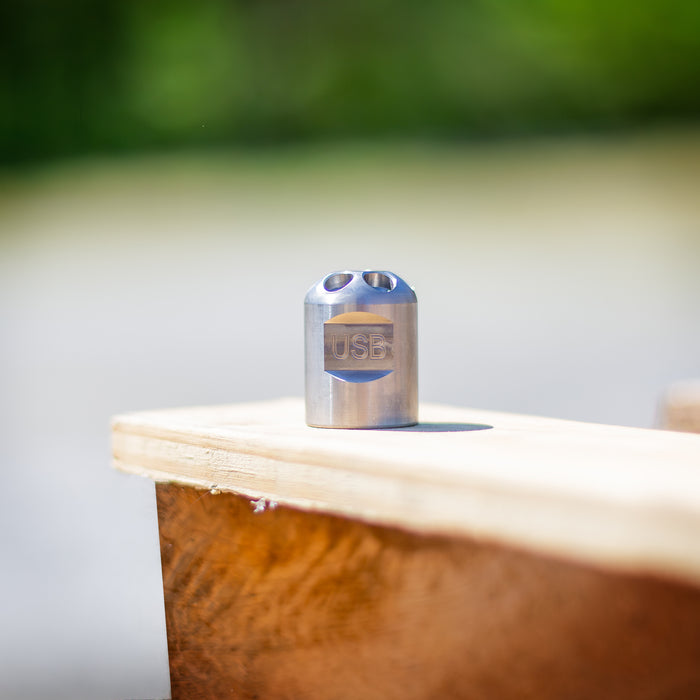 Stainless steel Digger Nozzle for sewer jetting, forward‑jet design with no rear jets to push debris and scale out of small pipes; manually pushed nozzle ideal for short runs under 100 feet during pipe‑lining prep, shown on a wooden surface for detailed product display.