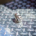 Digger sewer jetting nozzle on diamond plate metal surface – stainless steel front-jet nozzle designed for pushing debris, scale, and buildup through small pipes; no rear jets for maximum forward water pressure, ideal for pipe prep and short-run drain cleaning applications under 100 ft.